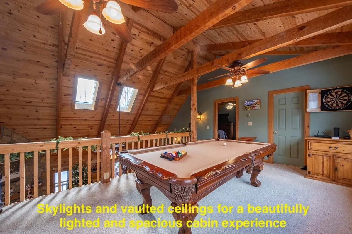 A vibrant interior with vaulted ceilings and skylights, focusing on a pool table surrounded by warm wooden decor. The playful yet relaxed mood invites guests to gather for games, echoing the fun and flexibility mentioned in the section.